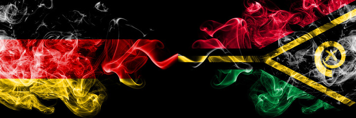 Germany vs Vanuatu smoky mystic flags placed side by side. Thick colored silky smoke flags of Deutschland and Vanuatu