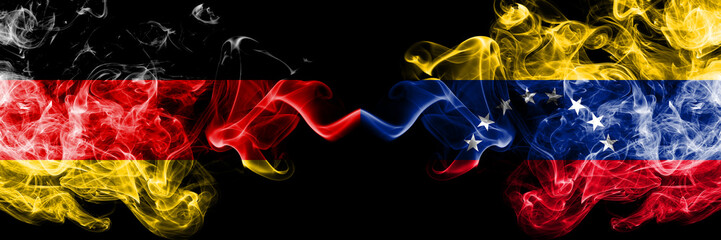 Germany vs Venezuela, Venezuelan smoky mystic flags placed side by side. Thick colored silky smoke flags of Deutschland and Venezuela, Venezuelan
