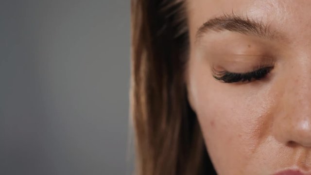 Close up macro view of beautiful green female woman girl student eye with long eyelashes, smooth healthy skin. Eyelash extension procedure. Perfect trendy eyebrows. Good vision, contact lenses. Eye