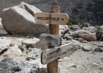 Trail juncture signs for the boulder field & privy & Longs Peak Trail in Rocky Mountain National...