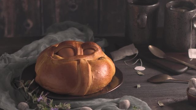 Easter folar with egg on wooden table top.