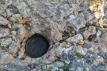 Horse footprint encrusted in rock from the famous legend of Fuas Roupinho. Naraze, Portugal