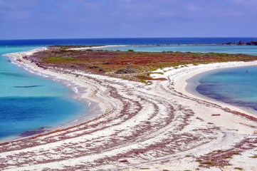 Sandy beach and island in the blue ocean