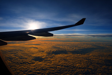 Fototapeta premium Top View of Clouds with Sunrise from Airplane Window.