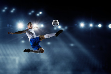 Fototapeta na wymiar Soccer player on stadium in action. Mixed media