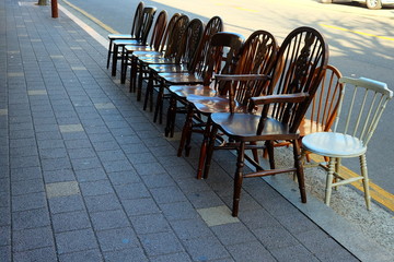 Old Wooden Chairs on Footpath.