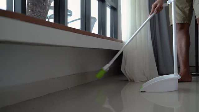 housekeeper is sweeping the floor during the day