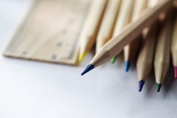 pencils and ruler on white table, close-up