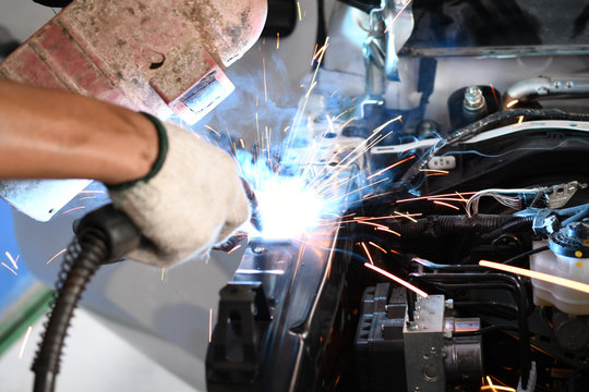 Men welder automotive part - auto body repair shop