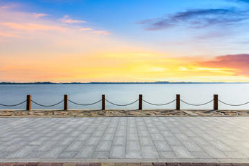 Fototapeta na wymiar Beautiful lake and walkway with sky clouds at sunset