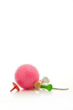 Pink Golf Ball, Divot REpair Tool, Colored Tees and Accessories Isolated on White Background