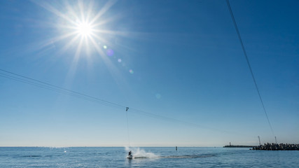 Wakeboardingnear seaport in Sochi. Sunshine on background. Russia.