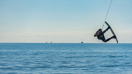 Wakeboarding on the sunny day near seaport in Sochi. Russia.