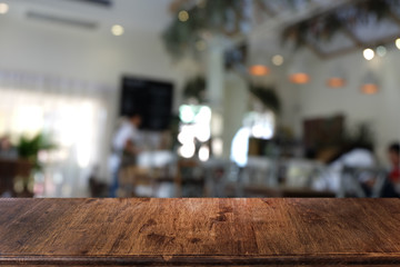 Empty dark wooden table in front of abstract blurred bokeh background of restaurant . can be used for display or montage your products.Mock up for space.