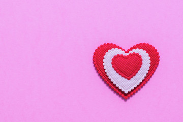 Bright red and white heart on pink background. The view from the top. Flat lay.
