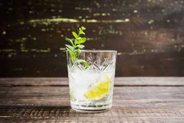 Old fashioned beverage with lime and mint leaves. Selective focus. Shallow depth of field.