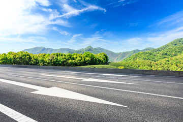 Country road and green mountains natural landscape under the blue sky