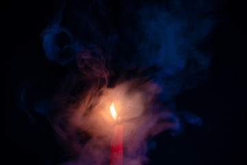 Candle fire with smoke, blue and orange gradient texture on a black background. Flame and colored smoke graphics