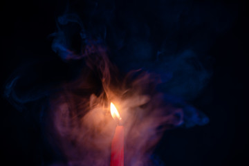 Candle fire with smoke, blue and orange gradient texture on a black background. Flame and colored smoke graphics