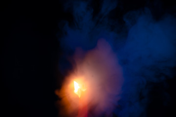 Candle fire with smoke, blue and orange gradient texture on a black background. Flame and colored smoke graphics