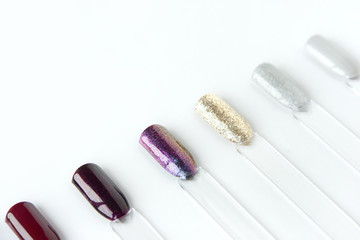 Nail polish samples in different bright colors. Colorful nail lacquer manicure swatches. Top view of nail art samples palette. Free copy space.