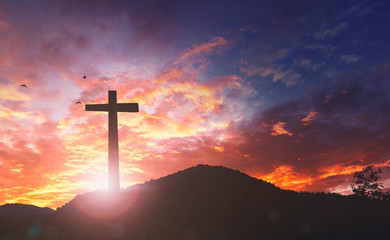 Silhouette the cross on sunset background