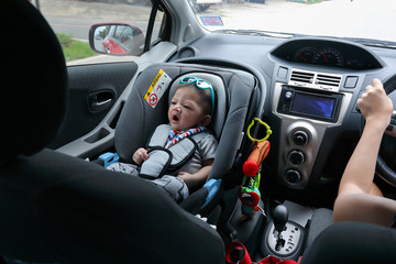 mother and son drive road trip family travel in summer vacation day, cute baby boy sitting on car seat