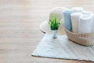 mockup towels in basket on wooden floor.
