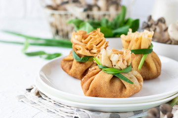 Pancake bags stuffed with with fried oyster mushrooms with spinach