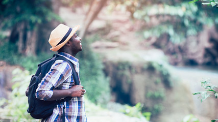 African man traveler smile and relax in jungle.Survival travel concept.