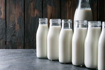 Fresh milk in different glass bottles