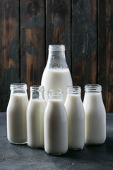 Fresh milk in different glass bottles