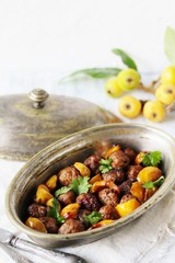 with a loquat dish. Meatballs with a loquat. or mini kebabs. medlar fruit with meatballs. Soft focus. Place for text. Copy Space