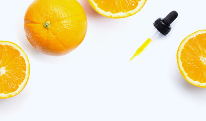 Essential oil with oranges on white.
