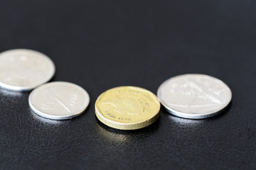 Several coins from Fiji on a dark background close up