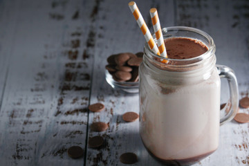 A glass jar with chocolate milk drink