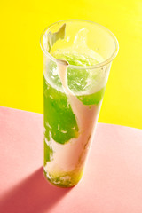 a kiwi juice that was taken a bite