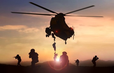 Fototapeta na wymiar Special force assault team helicopter drops during sunset