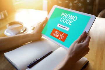 Tablet with promo code field on screen. E-commerce, mobile marketing concept.