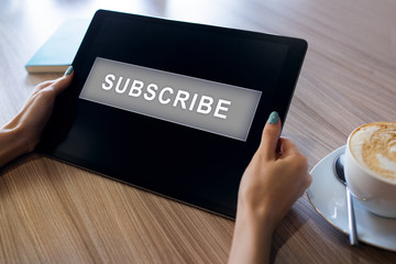 Subscribe button on device screen. Internet and digital marketing concept.