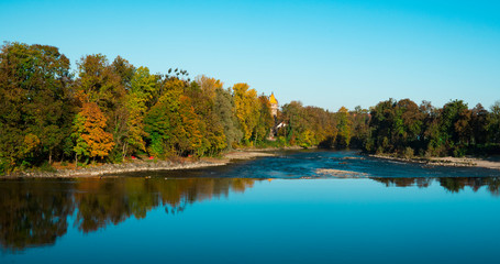Fototapeta premium trees in autumn colors along river Lech, in Landsberg am Lech, Germany