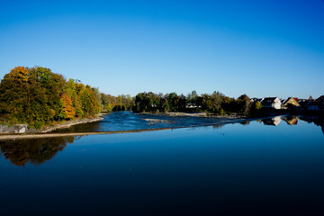 trees in autumn colors along river Lech, in Landsberg am Lech, Germany