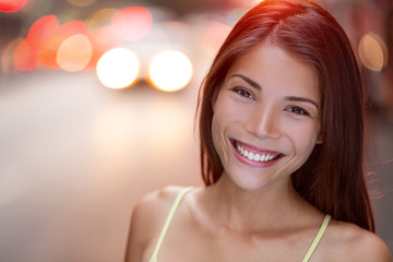 Obraz na płótnie Canvas Happy New York City woman smiling joyful in NYC with car traffic background. Mixed race Caucasian / Chinese Asian female girl real and candid.