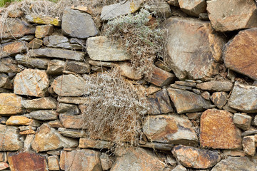 The texture of the stone. Natural mountain stone in the forest. Moss-covered stones in the forest. Granite stones close up.