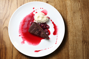 Chocolate brownie with raspberry sauce and ice cream.