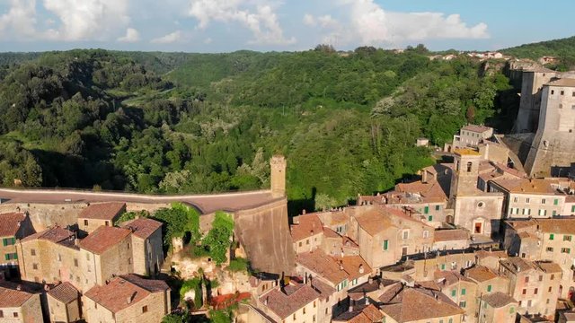 Flying over Sorano, Italy. Medieval hill town hanging from a tuff stone over the Lente River in the southern Tuscany. Aerial shot, 4K