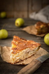 Apple pie on a wooden background, selective focus