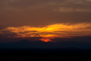 Sunset sky with silhouette mountain.