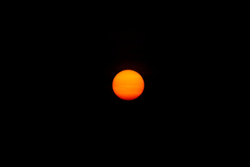 Soft sun on dark background.