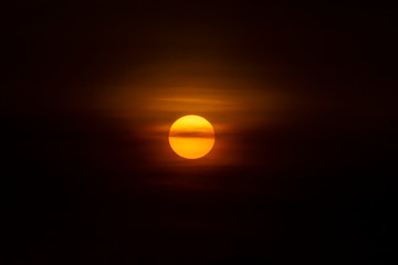 Big sun with soft cloud on sunset sky.